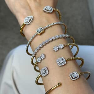 Minimalist open gold cuff bracelet featuring diamonds on both ends