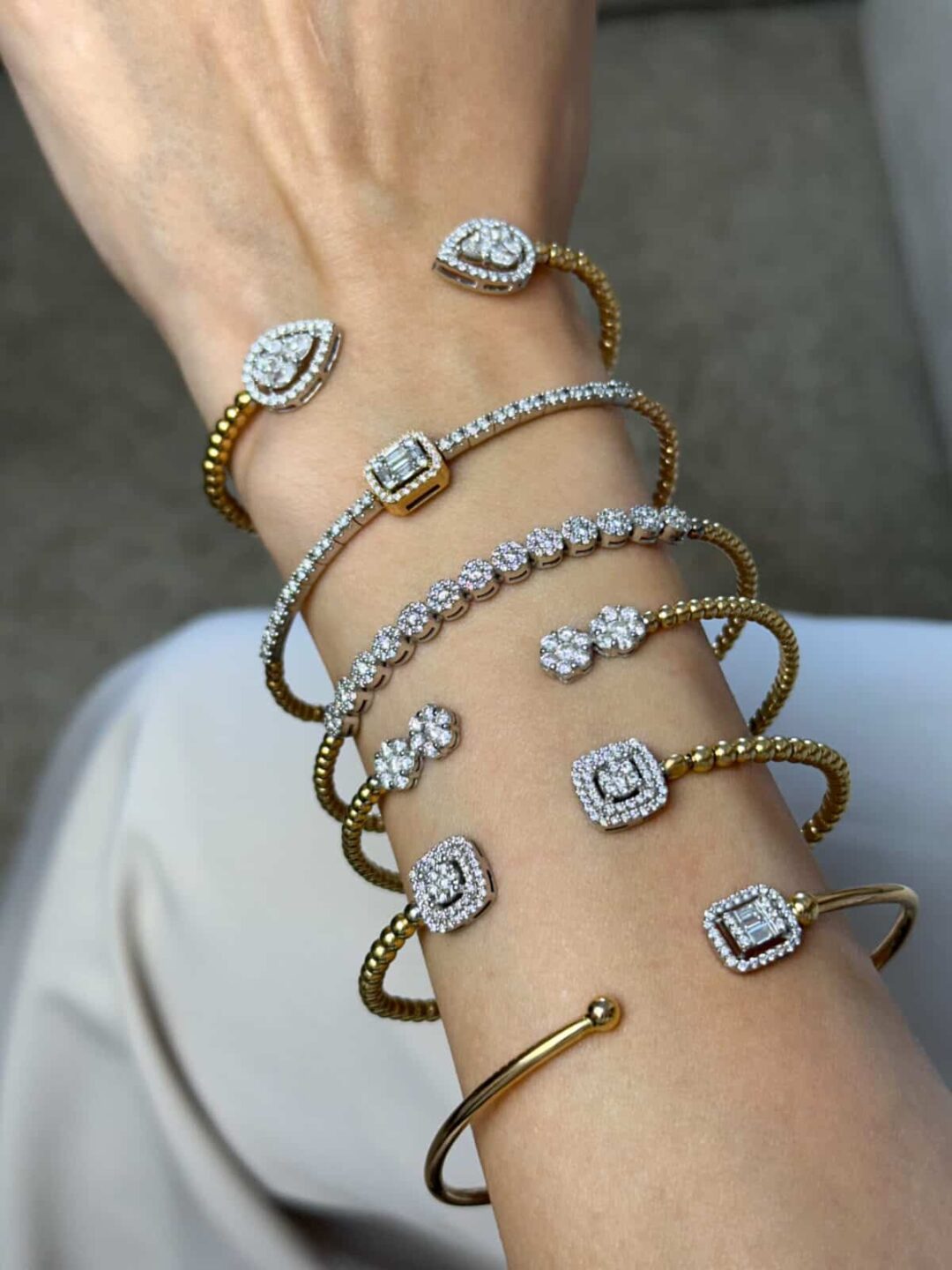 Minimalist open gold cuff bracelet featuring diamonds on both ends