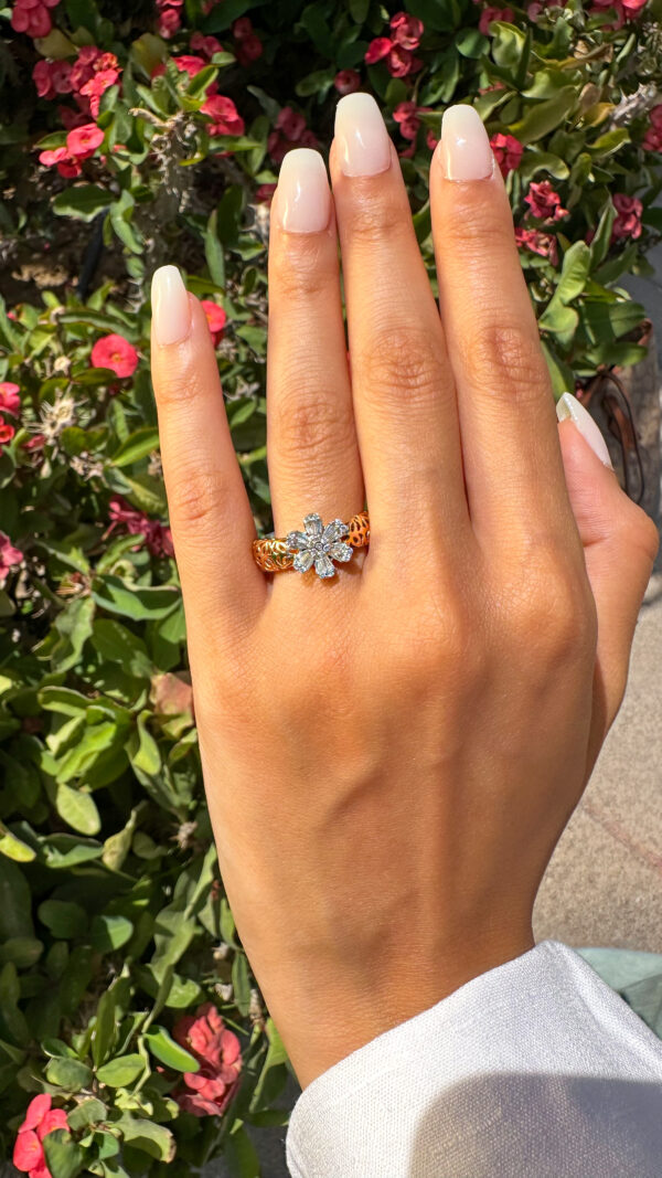 a girl wearing an 18k rose gold ring with diamonds in the form of a flower made by an expert Egyptian jeweller el galla jewellery