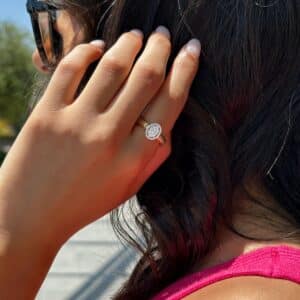model featured with her hand in her hair and wearing Sunlit Oval Diamond Ring