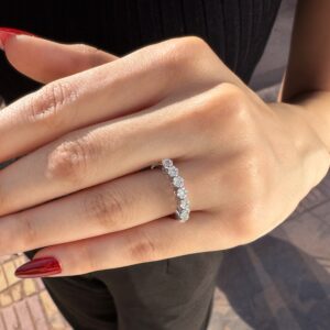 Classic white gold ring featuring a row of medium diamonds set across the center