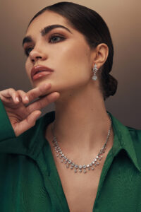 Elegant white gold necklace adorned with alternating geometric diamond settings and delicate diamond drop details