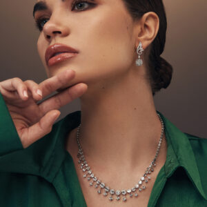 Elegant white gold necklace adorned with alternating geometric diamond settings and delicate diamond drop details