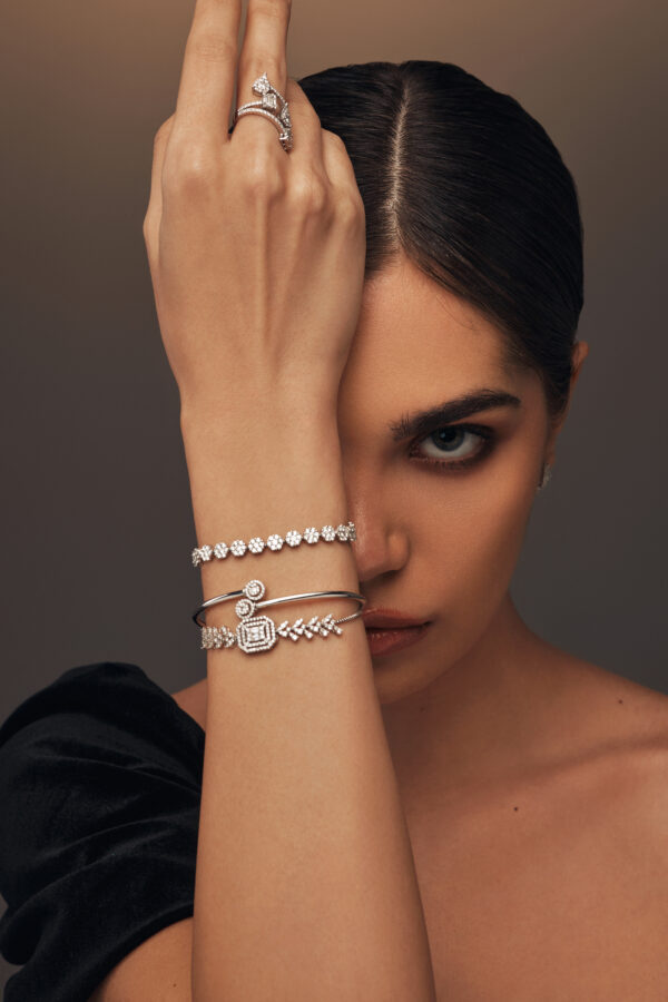 Elegant open white gold bangle featuring two diamonds on each tip