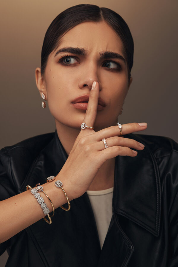 Elegant gold bracelet composed of small linked circles, embellished with five prominent diamond-set elements filled with sparkling smaller diamonds